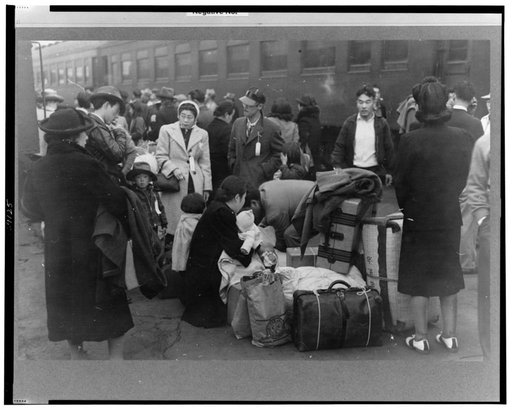 Los Angeles, California. Japanese-American evacuation from West Coast areas under U.S. Army war emergency order. Waiting with their luggage at the old Santa Fe station for a train to take them to Owens Valley