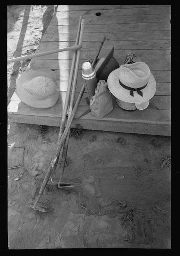 Nyssa, Oregon. FSA (Farm Security Administration) mobile camp. Hoes, lunch bags, and other belongings of Japanese-Americans farm workers who live at the camp