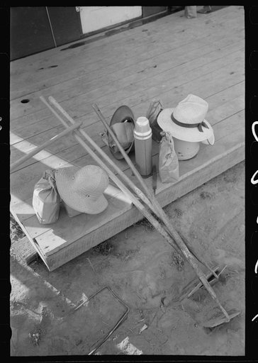 Nyssa, Oregon. FSA (Farm Security Administration) mobile camp. Hoes, lunch bags, and other belongings of Japanese-Americans farm workers who live at the camp