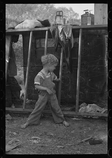 Son of destitute migrant, American River camp, near Sacremento, California. The boy has dysentery. See mount 9921-C
