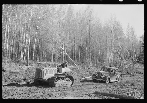 Untitled photo, possibly related to: FSA (Farm Security Administration) photographer being pulled out of mud by tractor, near Littlefork, Minnesota