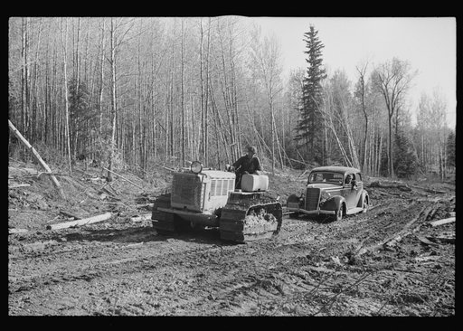 Untitled photo, possibly related to: FSA (Farm Security Administration) photographer being pulled out of mud by tractor, near Littlefork, Minnesota