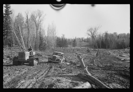Untitled photo, possibly related to: FSA (Farm Security Administration) photographer being pulled out of mud by tractor, near Littlefork, Minnesota