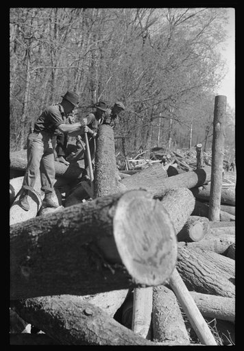 Untitled photo, possibly related to: Rolling logs into river near Littlefork, Minnesota