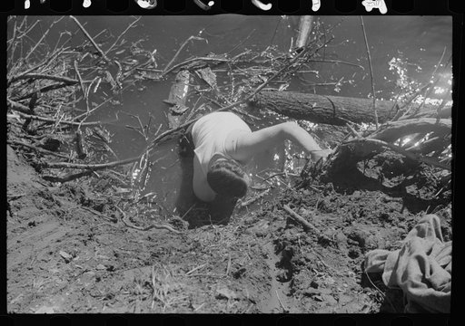 Untitled photo, possibly related to: Rolling logs into river, near Littlefork, Minnesota