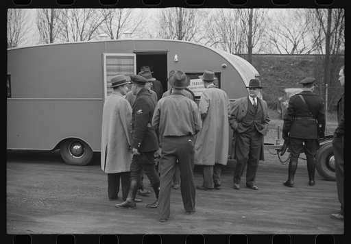 Untitled photo, possibly related to: Washington, D.C. A demonstration of FSA (Farm Security Administration) trailers. Bystanders and police escort inspecting a trailer