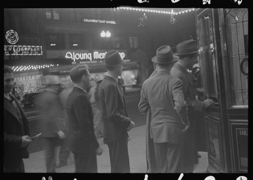 Washington, D.C. A street scene showing people waiting in line for tickets outside Loew's Capitol motion picture theatre