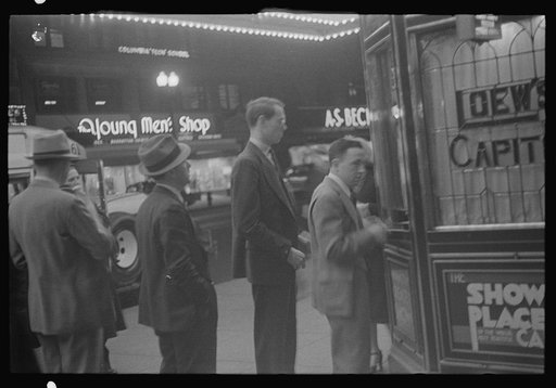 Untitled photo, possibly related to: Washington, D.C. A street scene showing people waiting in line for tickets outside Loew's Capitol motion picture theatre