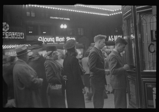 Untitled photo, possibly related to: Washington, D.C. A street scene showing people waiting in line for tickets outside Loew's Capitol motion picture theatre