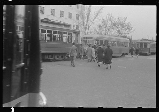 Untitled photo, possibly related to: Washington, D.C. A street scene in front of the United States Bureau of Engraving, showing workers boarding street cars on 14th Street
