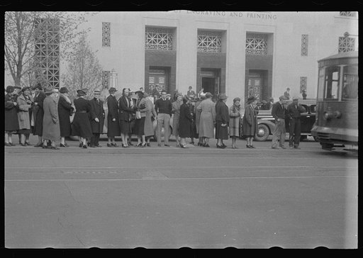 Untitled photo, possibly related to: Washington, D.C. A street scene in front of the United States Bureau of Engraving, showing workers boarding street cars on 14th Street