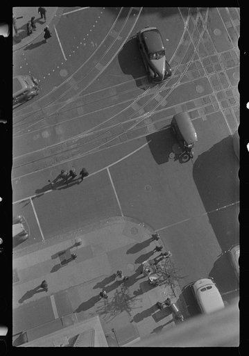 Washington, D.C. An aerial view of a street corner, 14th Street and Pennsylvania Avenue, showing pedestrians and automobiles