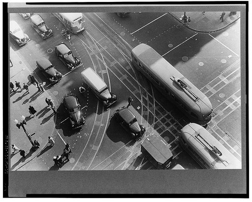 Washington, D.C. Aerial view of a street corner, in front of the Willard Hotel, at 14th Street and Pennsylvania Avenue showing pedestrians and rather dense traffic in autos and street cars