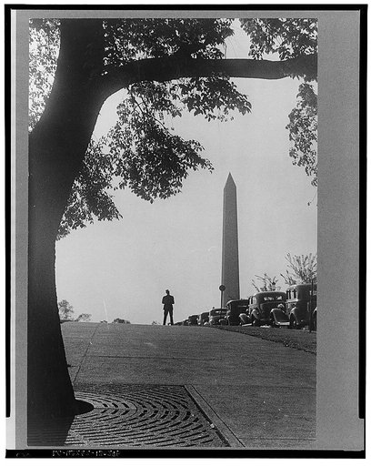 Washington, D.C. A view of the Washington Monument, looking west over cars parked along the Mall