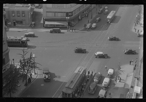 Untitled photo, possibly related to: Washington, D.C. A street scene showing street cars crossing at 14th Street and New York Avenue, photographed from a building near the Lotus Club