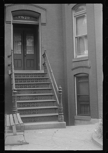 Washington, D.C. The entrance to a rowhouse, showing a card in the window advertising rooms and board