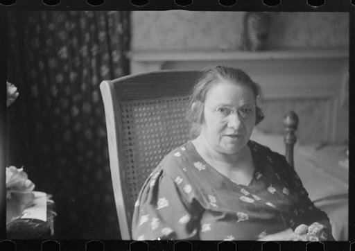 Untitled photo, possibly related to: Washington, D.C. A woman doing handwork in her bedroom