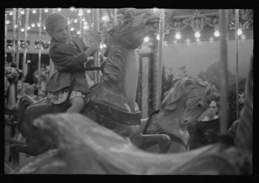 Glen Echo, Maryland. A small girl enjoying a ride on the merry-go-round at Glen Echo Park