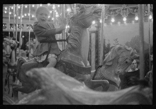 Glen Echo, Maryland. A small girl enjoying a ride on the merry-go-round at Glen Echo Park