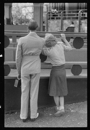 Untitled photo, possibly related to: Glen Echo, Maryland. A young couple watching people on "the whip," at Glen Echo Park