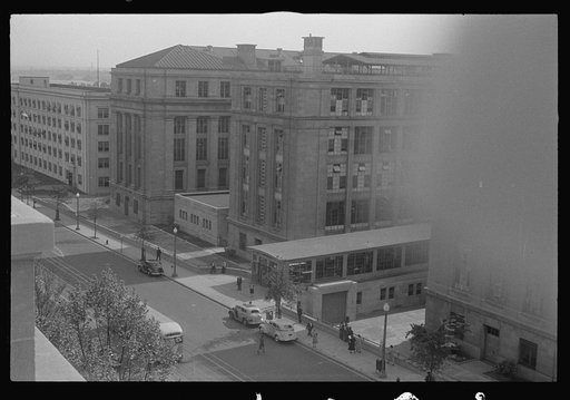 Untitled photo, possibly related to: Washington, D.C. A view of 14th Street showing street cars, buses, taxicabs, and pedestrians in front of the U.S. Bureau of Engraving Building, photographed from the U.S. Deptartment of Agriculture South Building