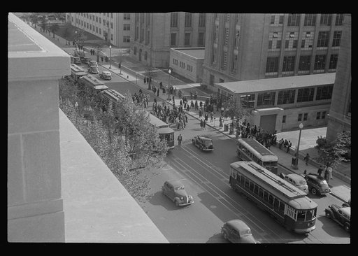 Untitled photo, possibly related to: Washington, D.C. A view of 14th Street showing street cars, buses, taxicabs, and pedestrians in front of the U.S. Bureau of Engraving Building, photographed from the U.S. Deptartment of Agriculture South Building
