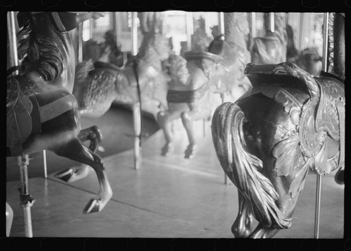 Untitled photo, possibly related to: Glen Echo, Maryland. A small girl enjoying a ride on the merry-go-round at Glen Echo Park