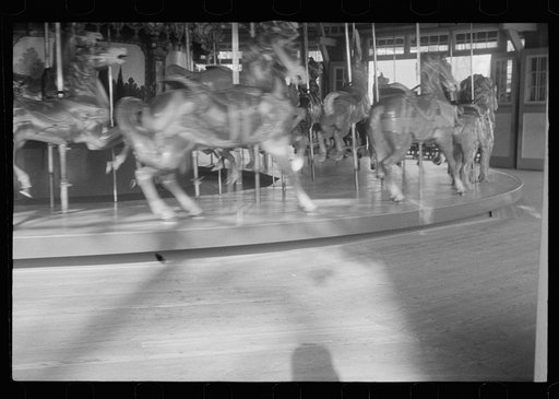 Untitled photo, possibly related to: Glen Echo, Maryland. A small girl enjoying a ride on the merry-go-round at Glen Echo Park
