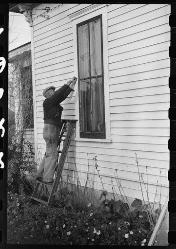 Putting up storm windows. Hillsboro, North Dakota