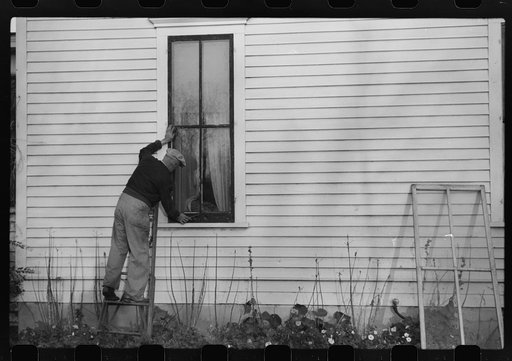 Putting up storm windows. Hillsboro, North Dakota