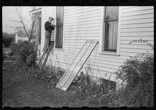 Untitled photo, possibly related to: Putting up storm windows. Hillsboro, North Dakota