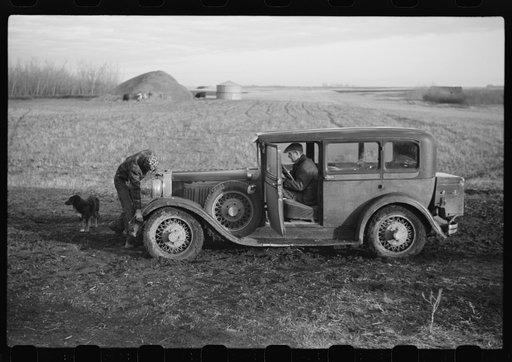 Oldest Sauer boy cranking family car. Cavalier County, North Dakota