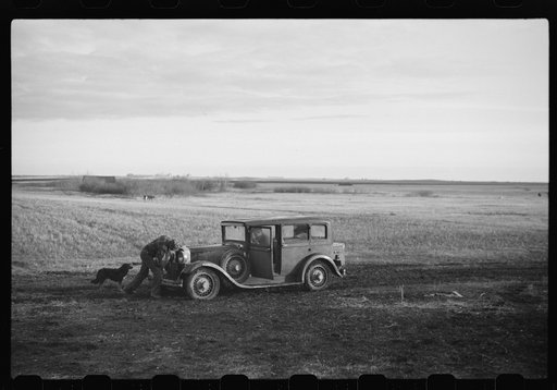 Untitled photo, possibly related to: Oldest Sauer boy cranking family car. Cavalier County, North Dakota