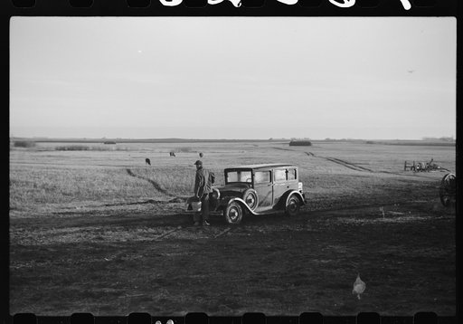 Untitled photo, possibly related to: Oldest Sauer boy cranking family car. Cavalier County, North Dakota