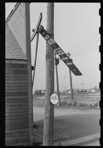 Untitled photo, possibly related to: Metal sign blowing in the wind. Doyon, North Dakota