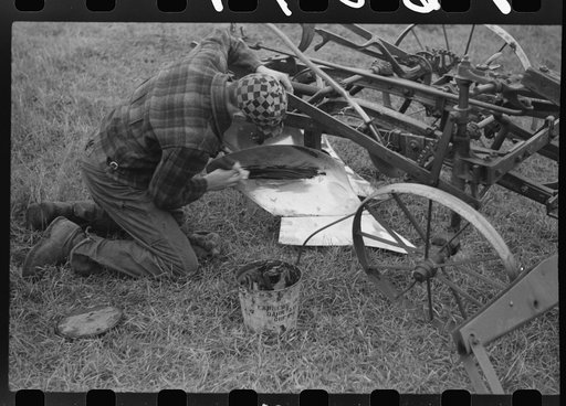 Greasing plow point for the winter. Cavalier County, North Dakota
