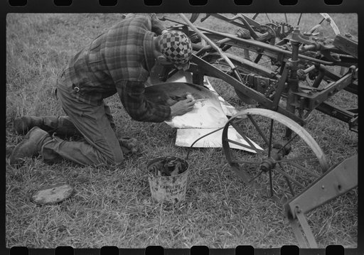 Untitled photo, possibly related to: Greasing plow point for the winter. Cavalier County, North Dakota