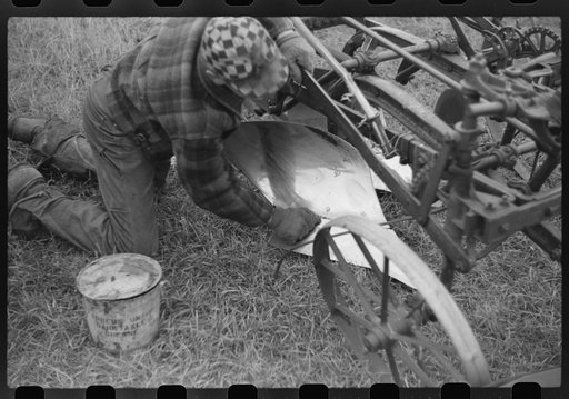 Untitled photo, possibly related to: Greasing plow point for the winter. Cavalier County, North Dakota
