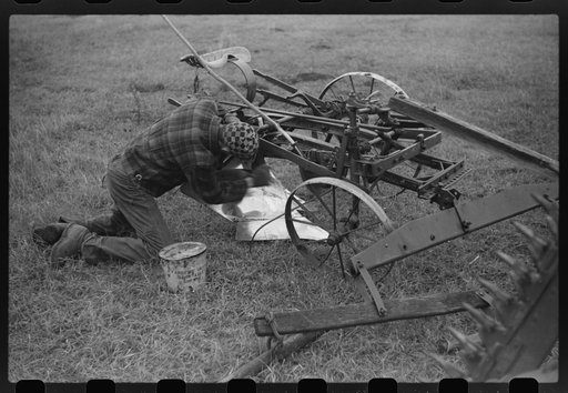 Untitled photo, possibly related to: Greasing plow point for the winter. Cavalier County, North Dakota