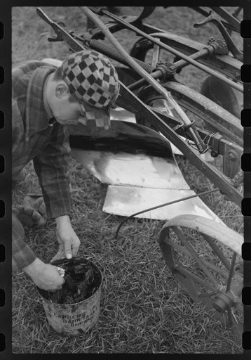 Greasing plow which will remain outdoors during the winter, Cavalier County, North Dakota