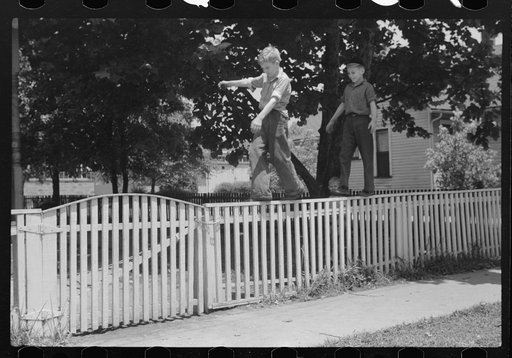Boys walking fence. Washington, Indiana