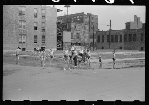 Untitled photo, possibly related to: Cooling off in water from hydrant, Chicago, Illinois