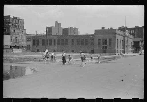 Untitled photo, possibly related to: Cooling off in water from hydrant, Chicago, Illinois