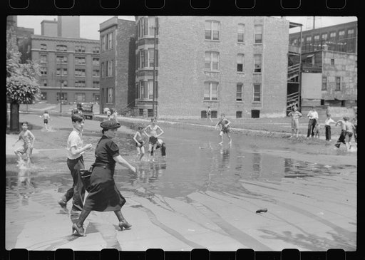 Cooling off in water from hydrant, Chicago, Illinois
