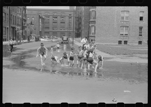 Cooling off in water from hydrant, Chicago, Illinois