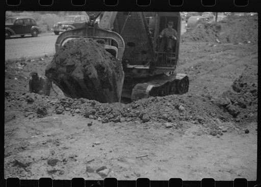 Untitled photo, possibly related to: Steam shovel loading truck, Chicago, Illinois