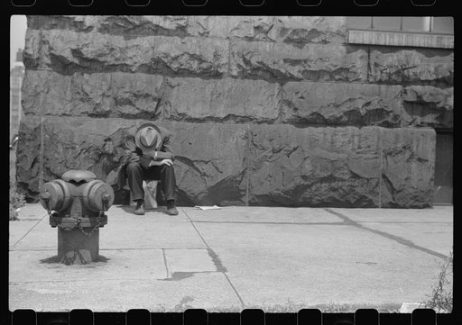 Man seated on corner of Jefferson Street and Vernon Park Place,] Chicago, Illinois