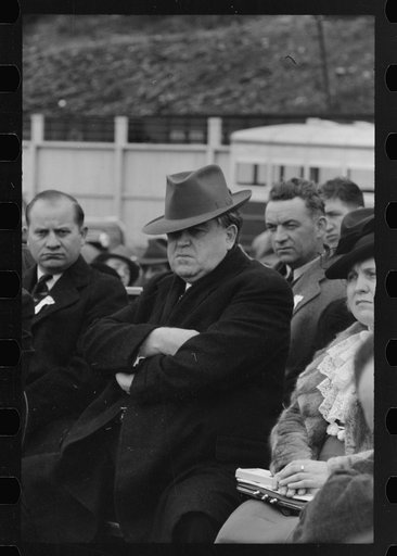 Untitled photo, possibly related to: Shenandoah, Pennsylvania? John L. Lewis, center, at the stadium on the occasion of a district(?) meeting of the mine workers, seen among a crowd of people