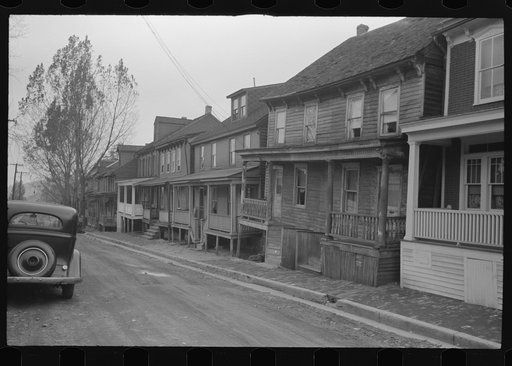 Shenandoah(?), Pennsylvania. Homes of a mining town on an unpaved street, built out to the edge of narrow brick sidewalks