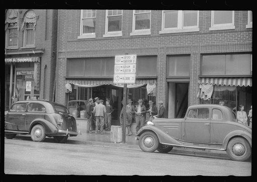 Untitled photo, possibly related to: Negroes standing on the corner of the main street on rainy Memorial Day.  Roxboro, North Carolina